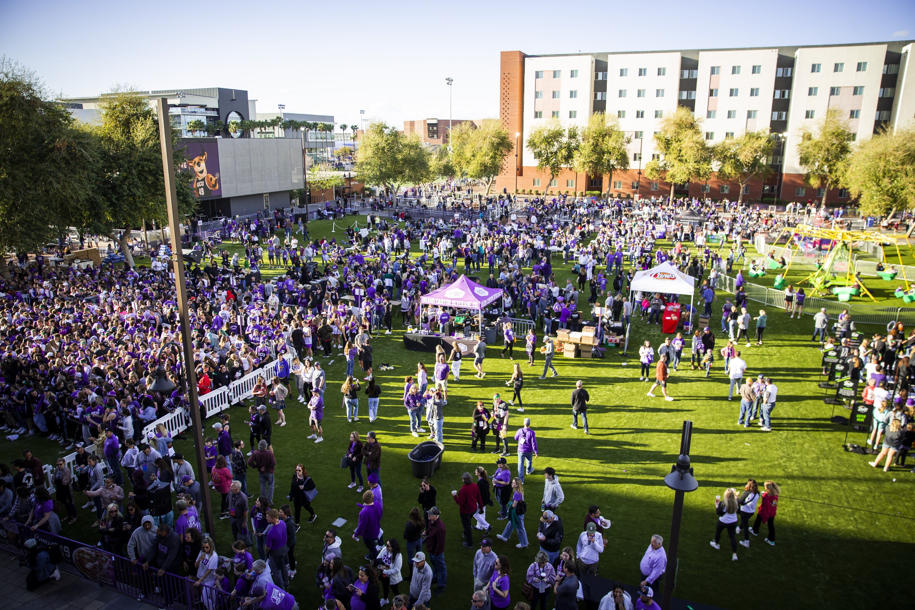 Birds eye view of families gathered on the field for Family Weekend