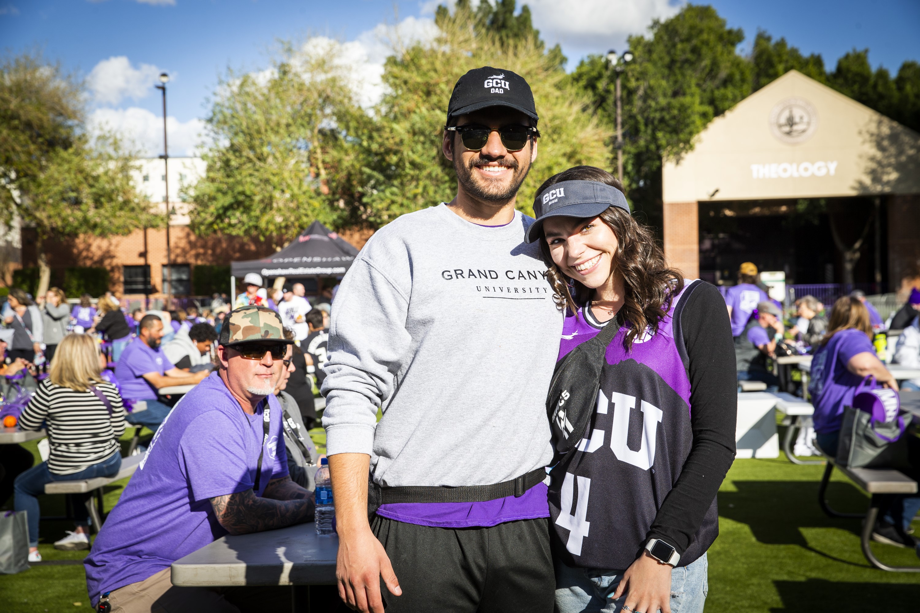 GCU student and her father smiling together on the field during Family Weekend