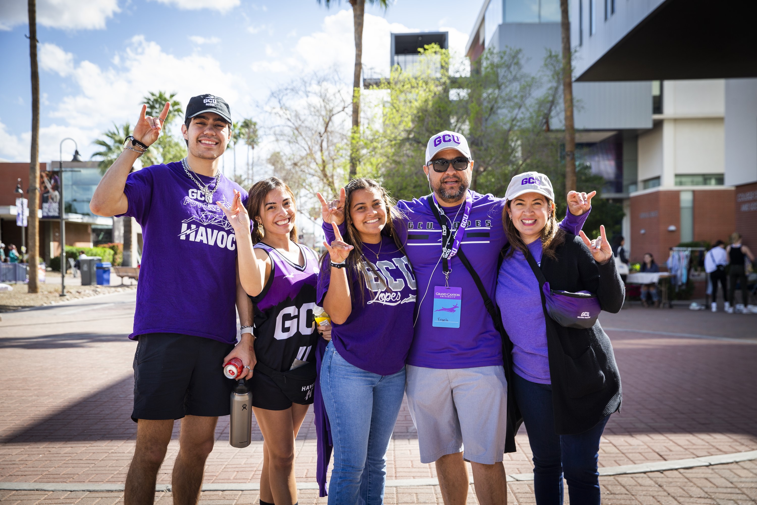 Family holding lopes up on campus during Family Weekend