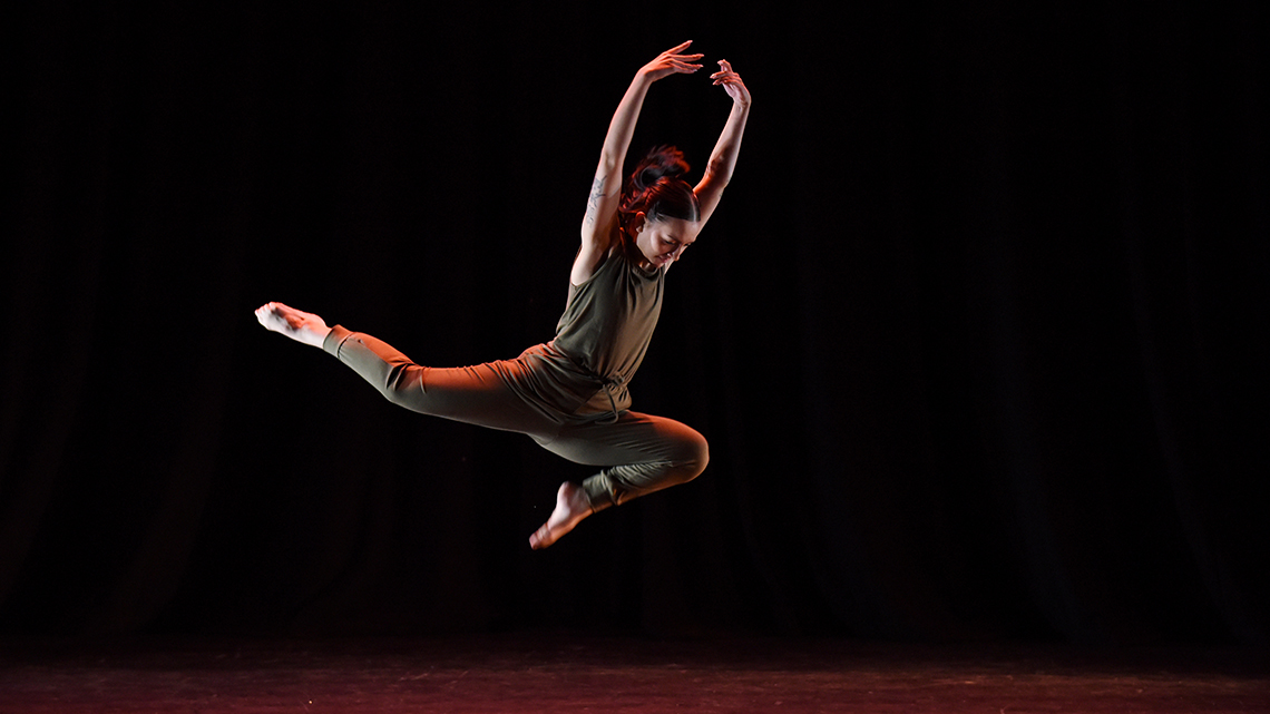 Bent jete leap into the air in the Intertwine spring dance showcase by Kiera Boatman