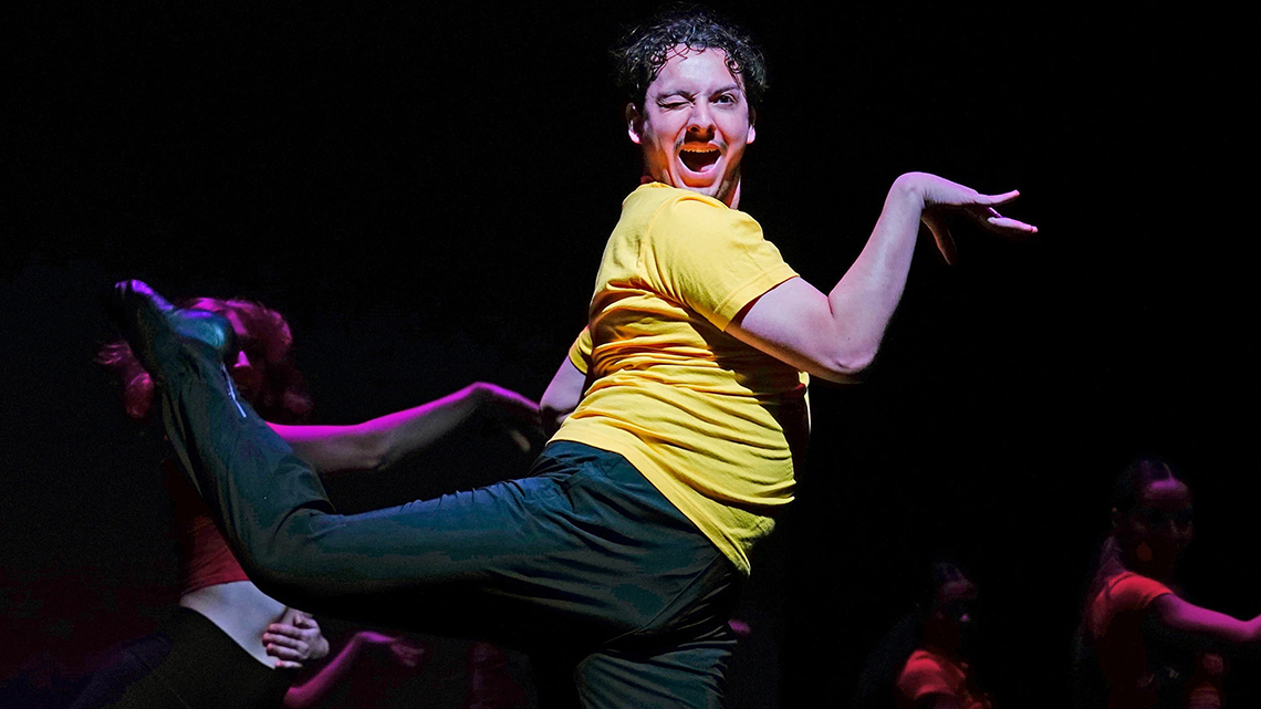 Dancer Jonathan Gerardo in a fun jazz number winks when moving swiftly through the movement in a pale yellow top and black pants
